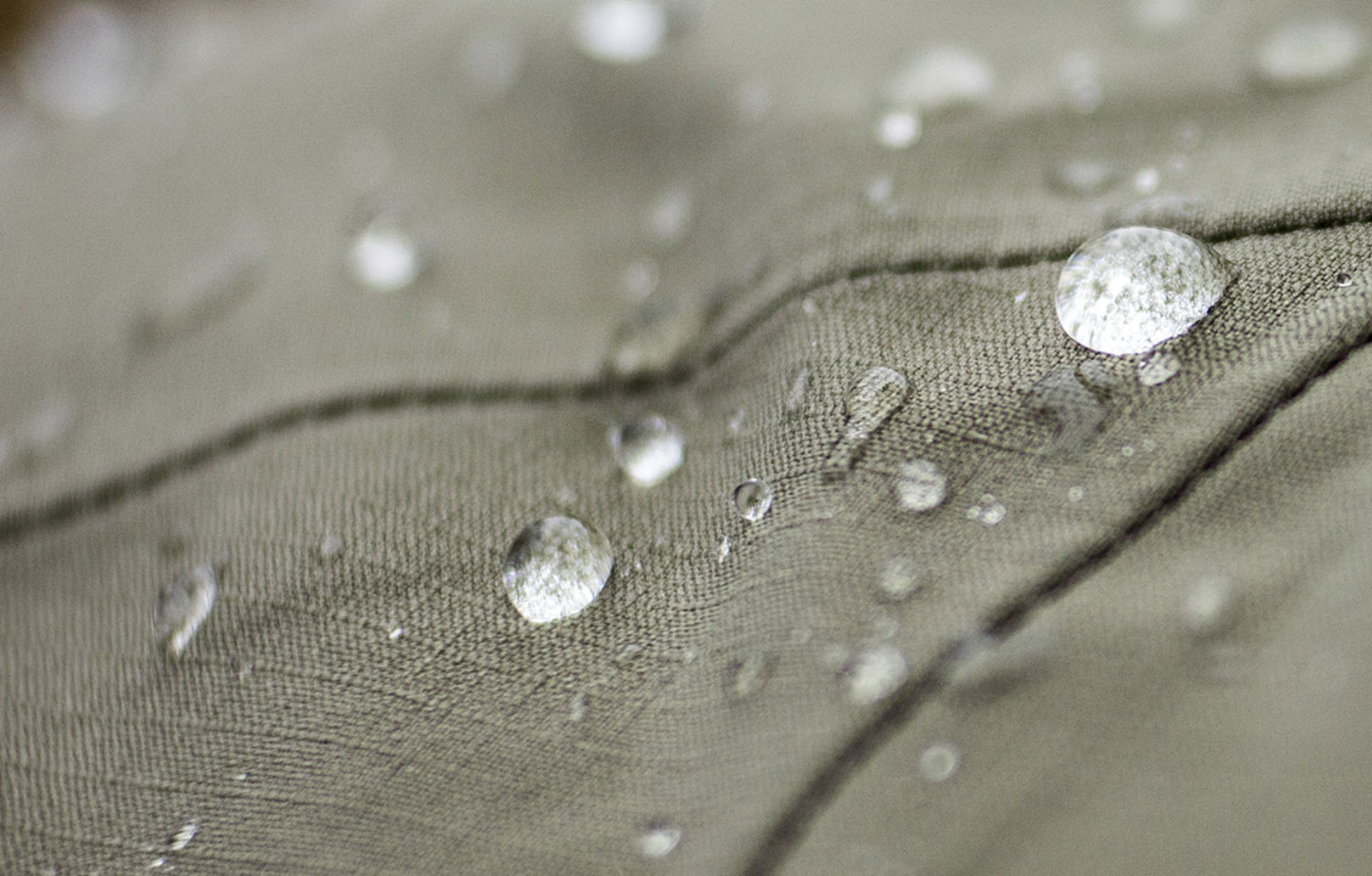 image of a piece of  eco-shell fabric with water beading on it